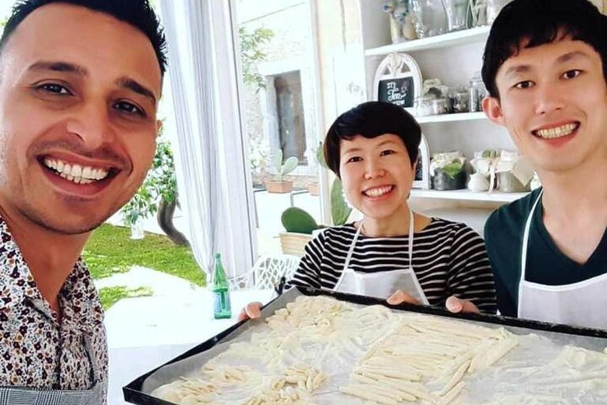 dua lelaki dan seorang budak lelaki memegang dulang makanan