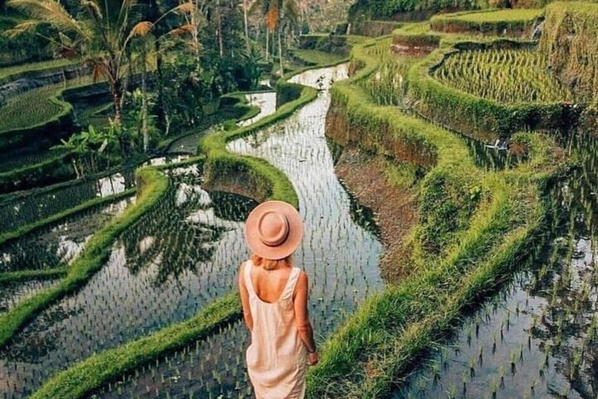 a woman in an orange hat looking down at a river