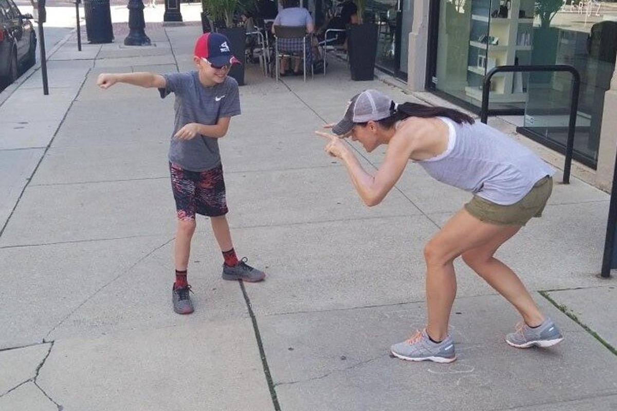 a young boy and a girl playing with a ball