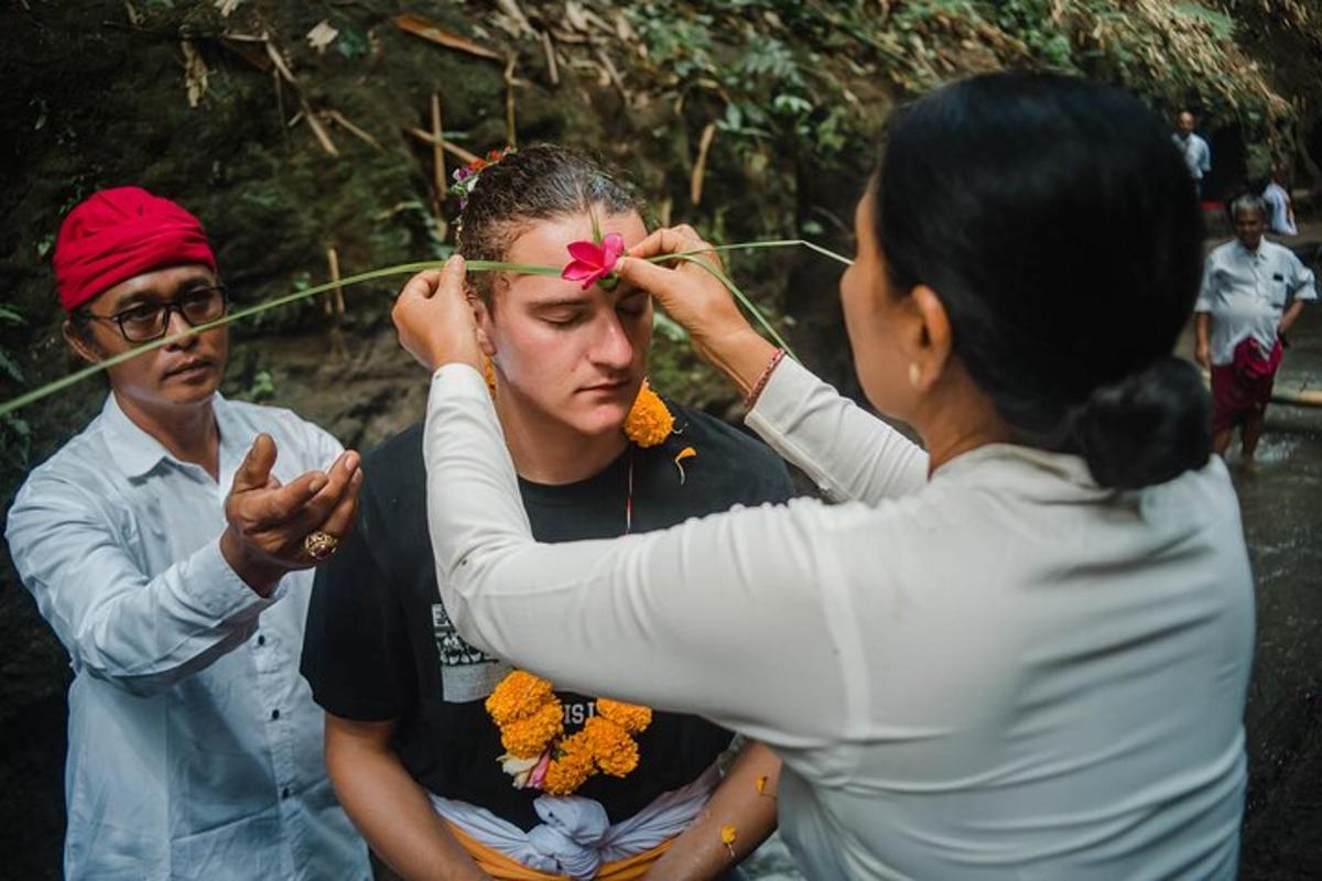 a woman cutting a mans hair with a flower on his head