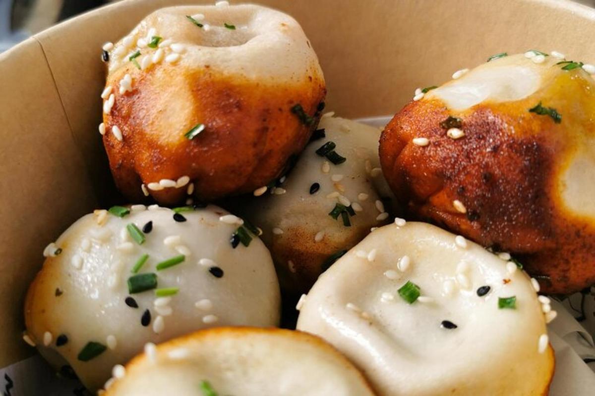 a box of donuts with chives on top of them