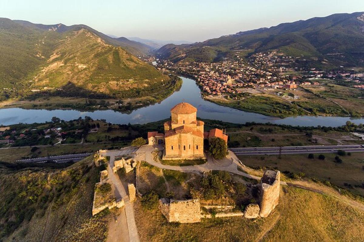 an aerial view of a castle on a mountain