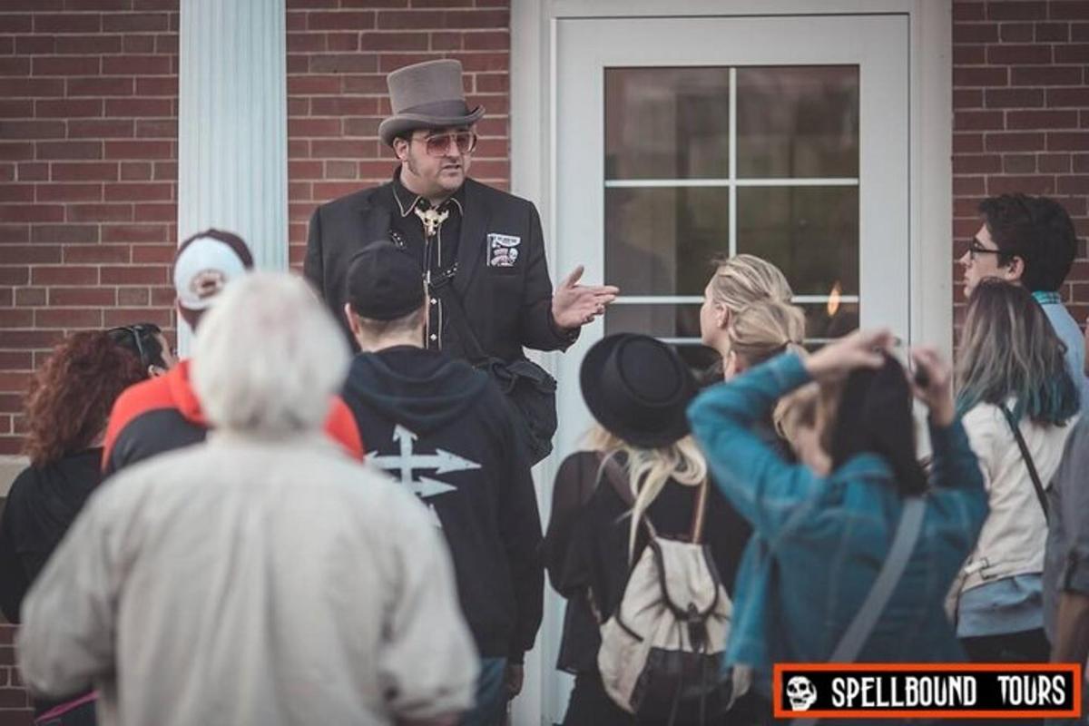 a man in a top hat standing in front of a group of people