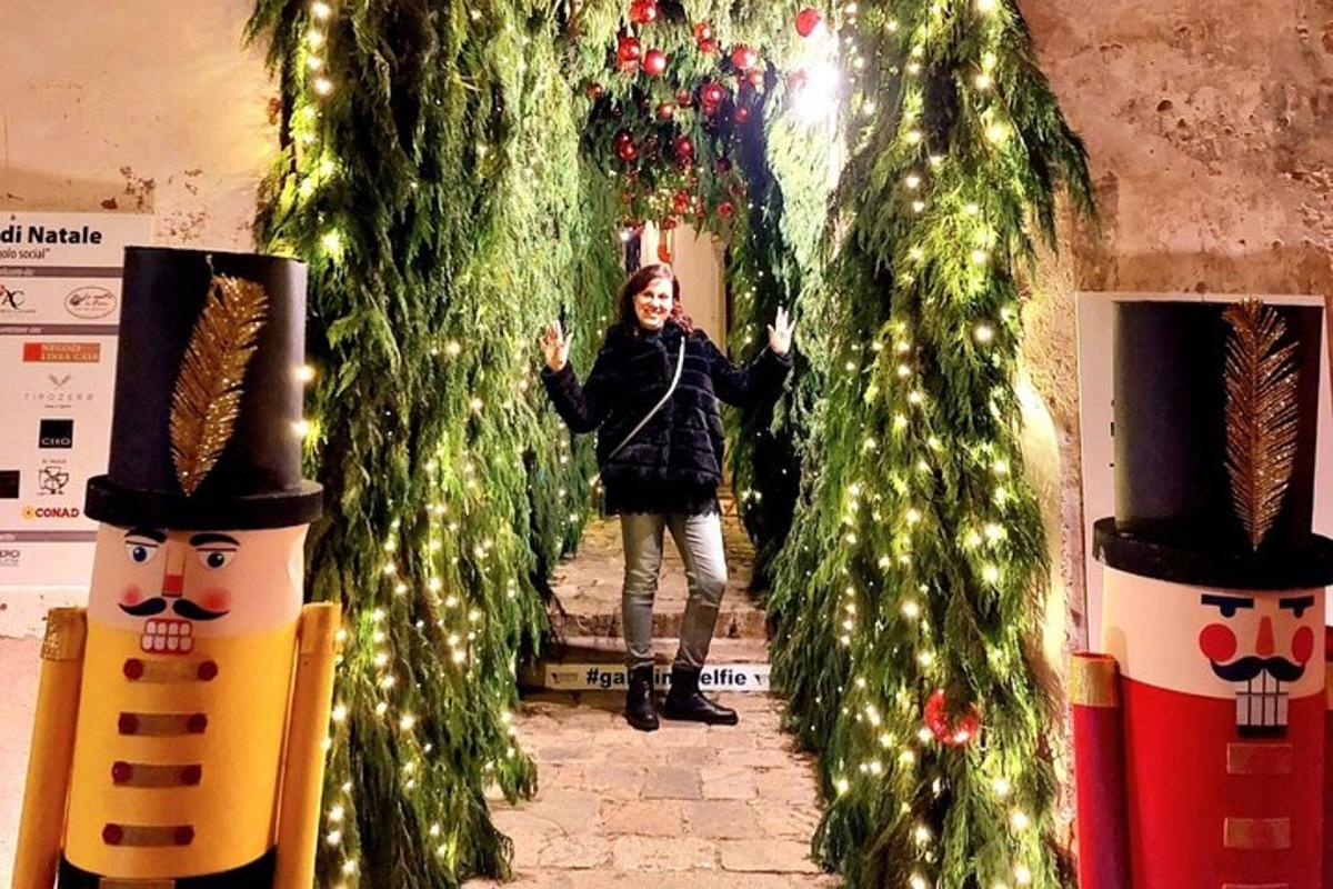 a woman is standing between two christmas trees