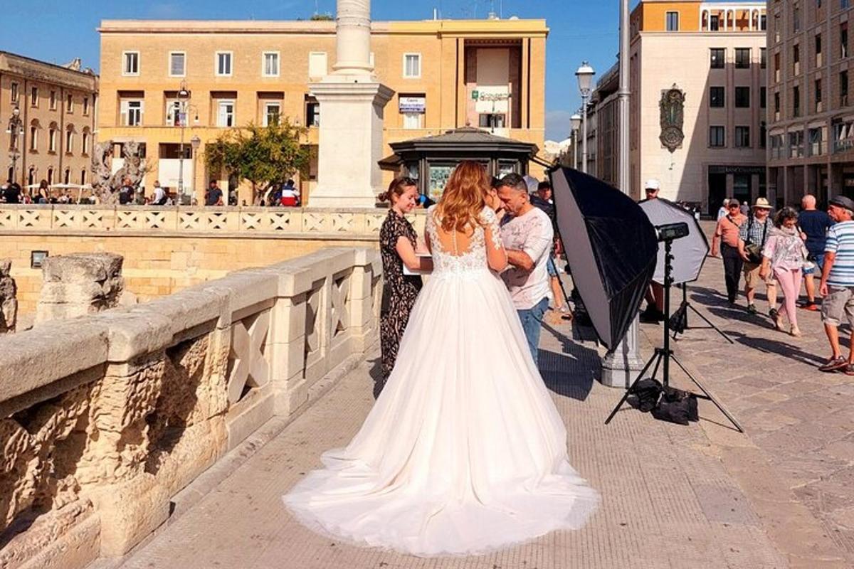 a bride and groom standing on a bridge