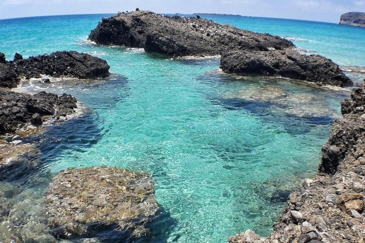 a body of water with rocks and the ocean