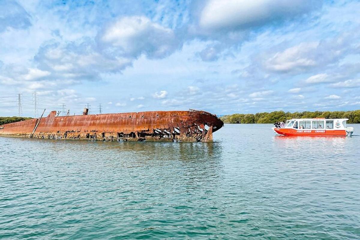 a red boat and a rusty object in the water