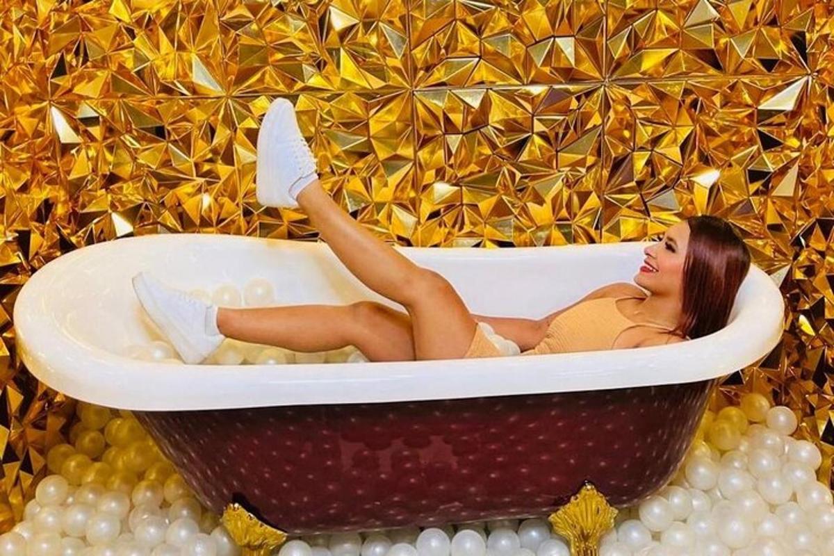 a woman laying in a bath tub in a wall