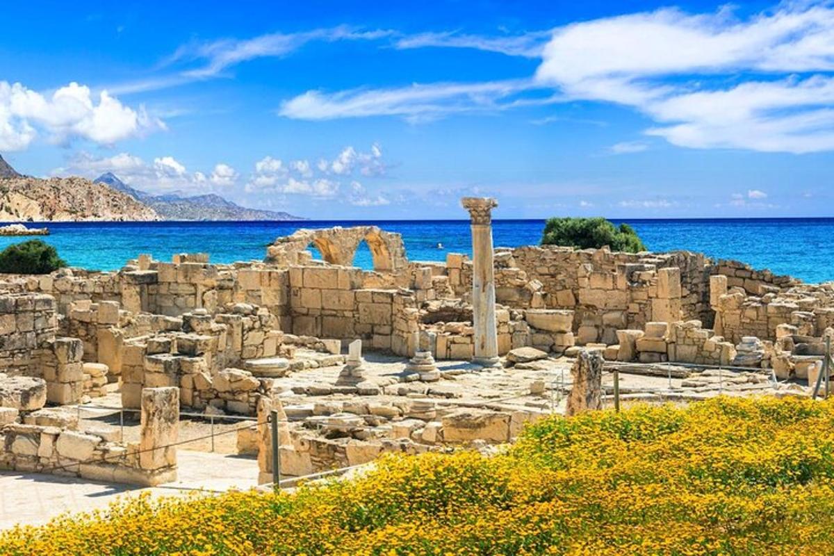 ancient ruins on the beach with the ocean in the background