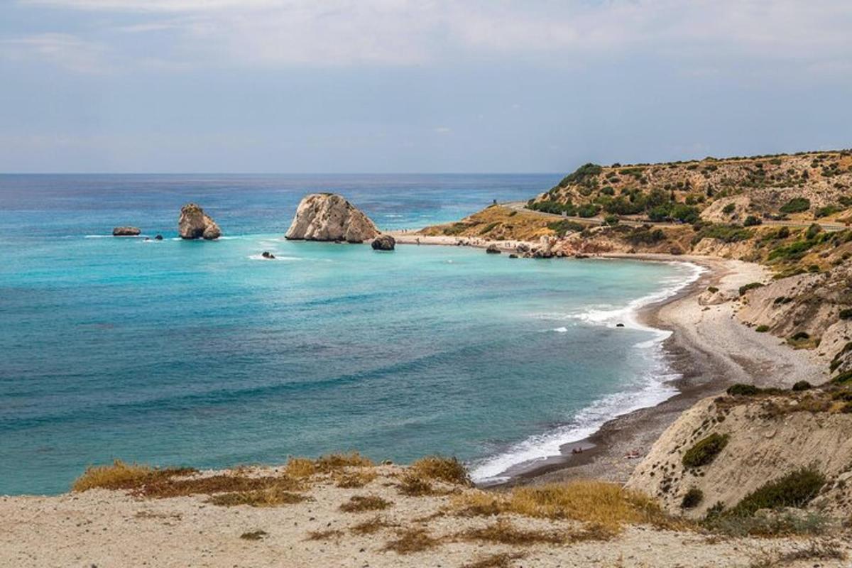 a beach with two large rocks in the water