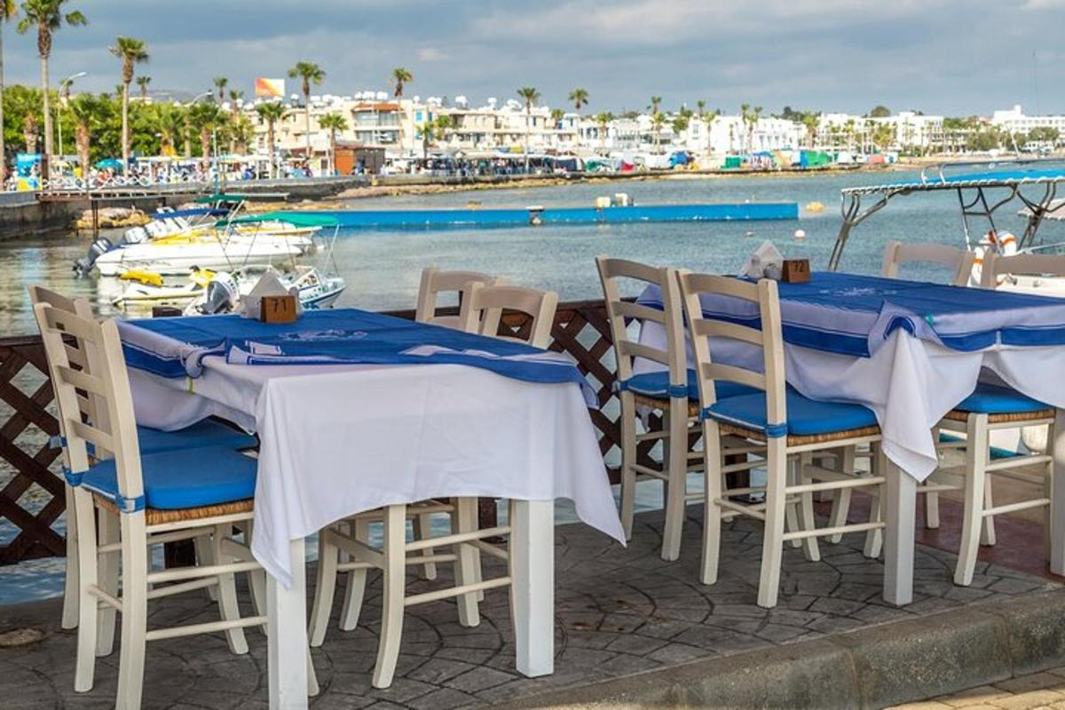 two tables and chairs with a view of the water