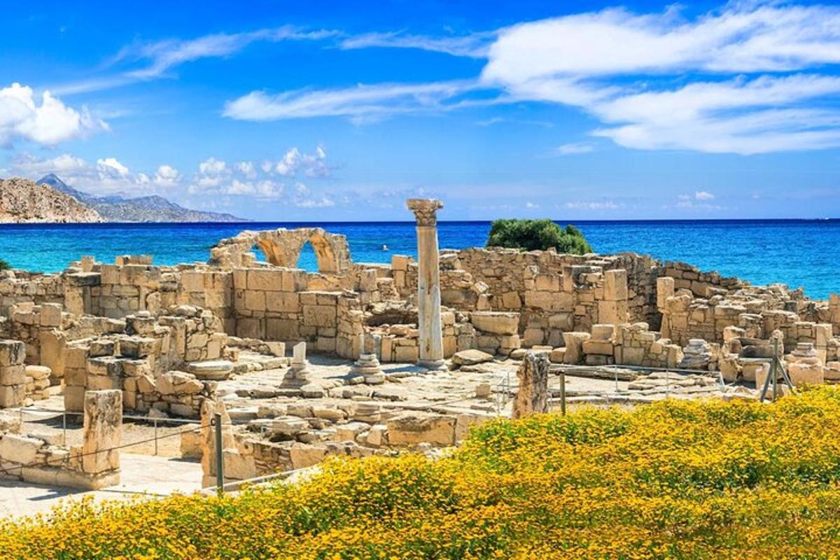 ancient ruins on the beach with the ocean in the background