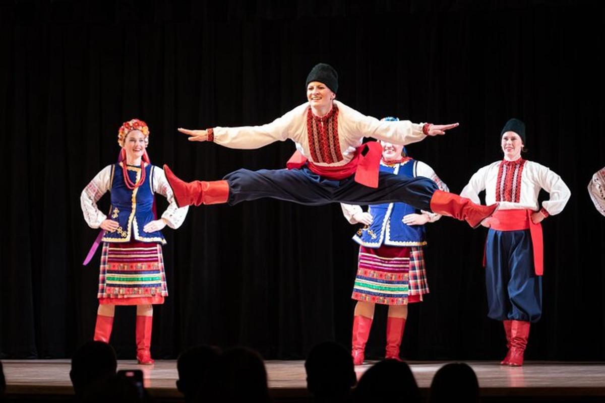 a group of people in folk dances on a stage