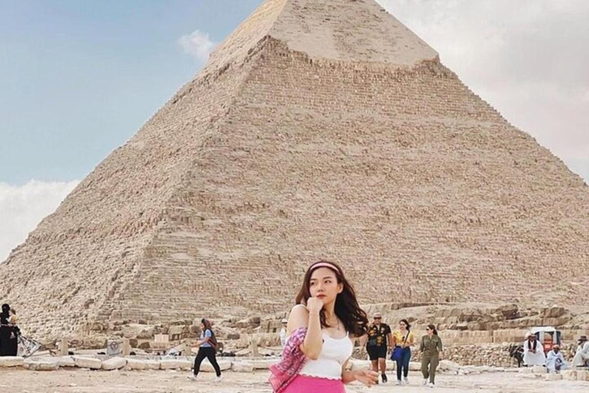 žena stojaca pred pyramídou