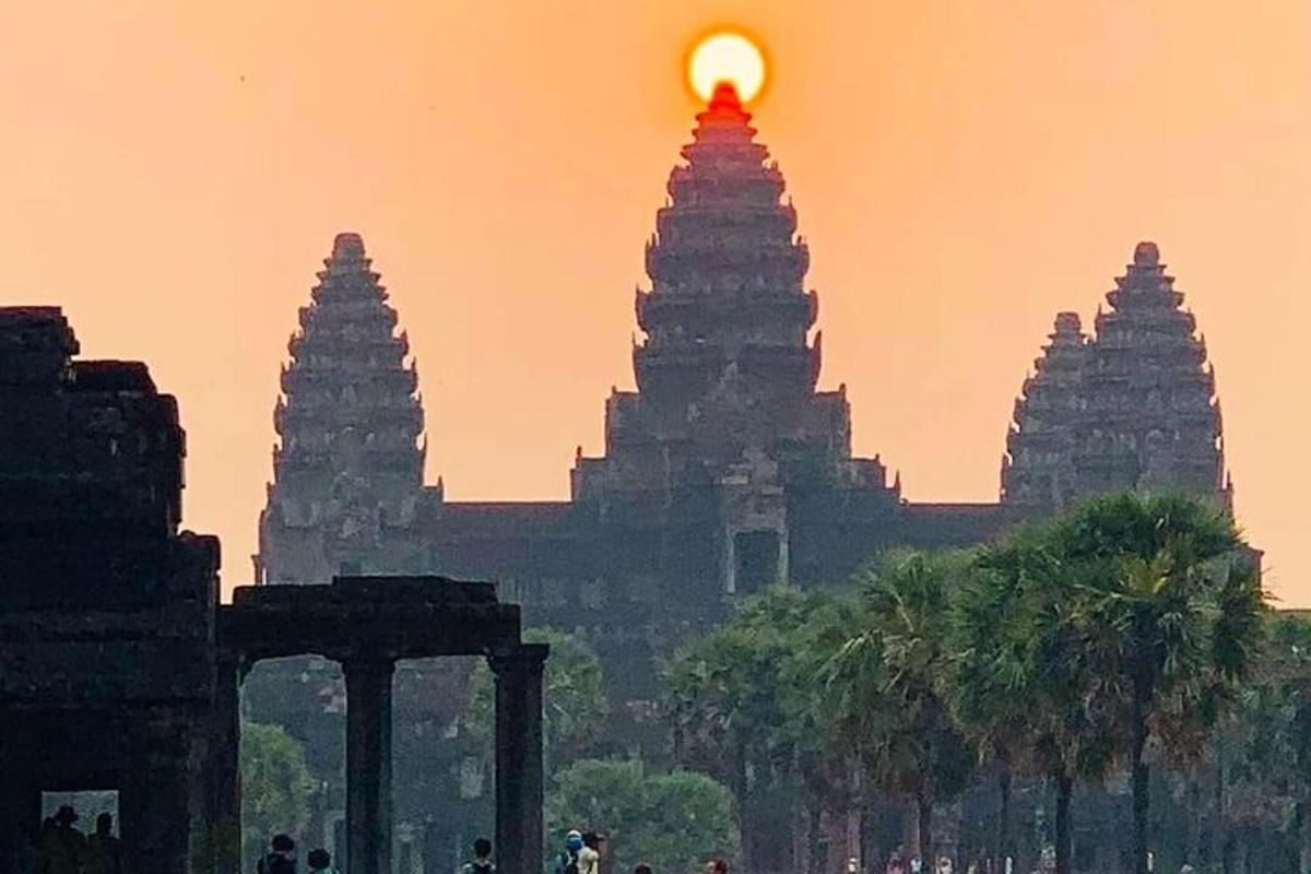 a group of pagodas with a sunset in the background