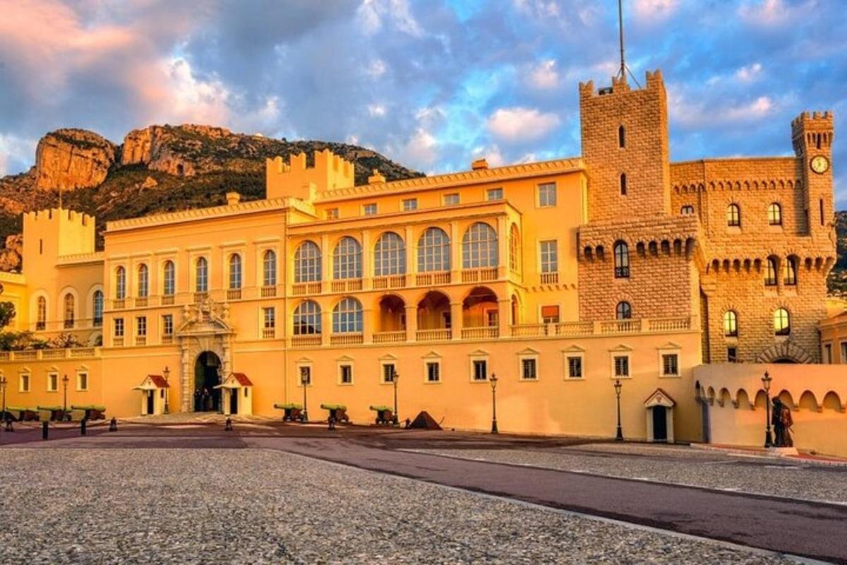 a large yellow building with a mountain in the background
