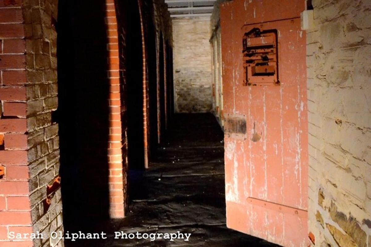 an empty hallway in an old brick building