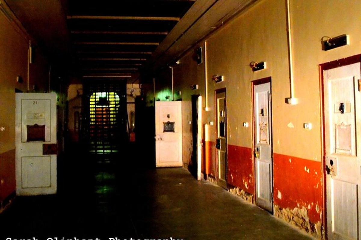 an empty hallway of a building with a room withapons