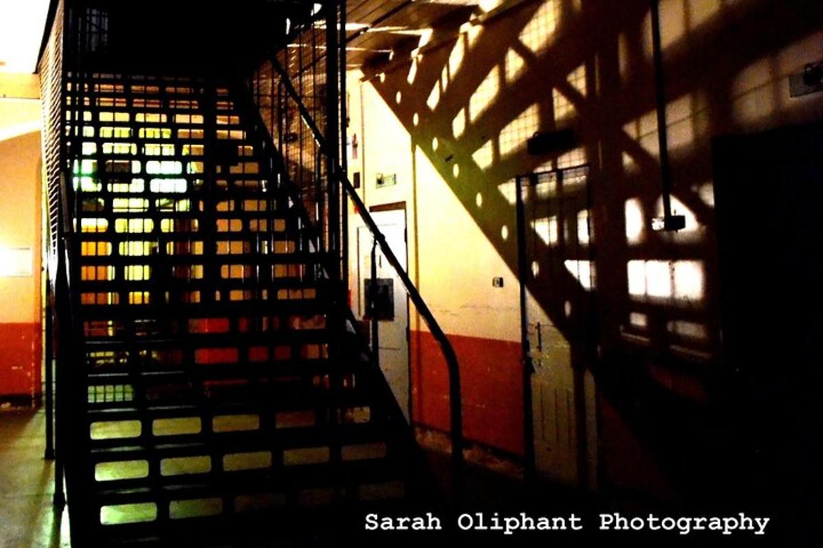 a metal staircase in a building with lights on it