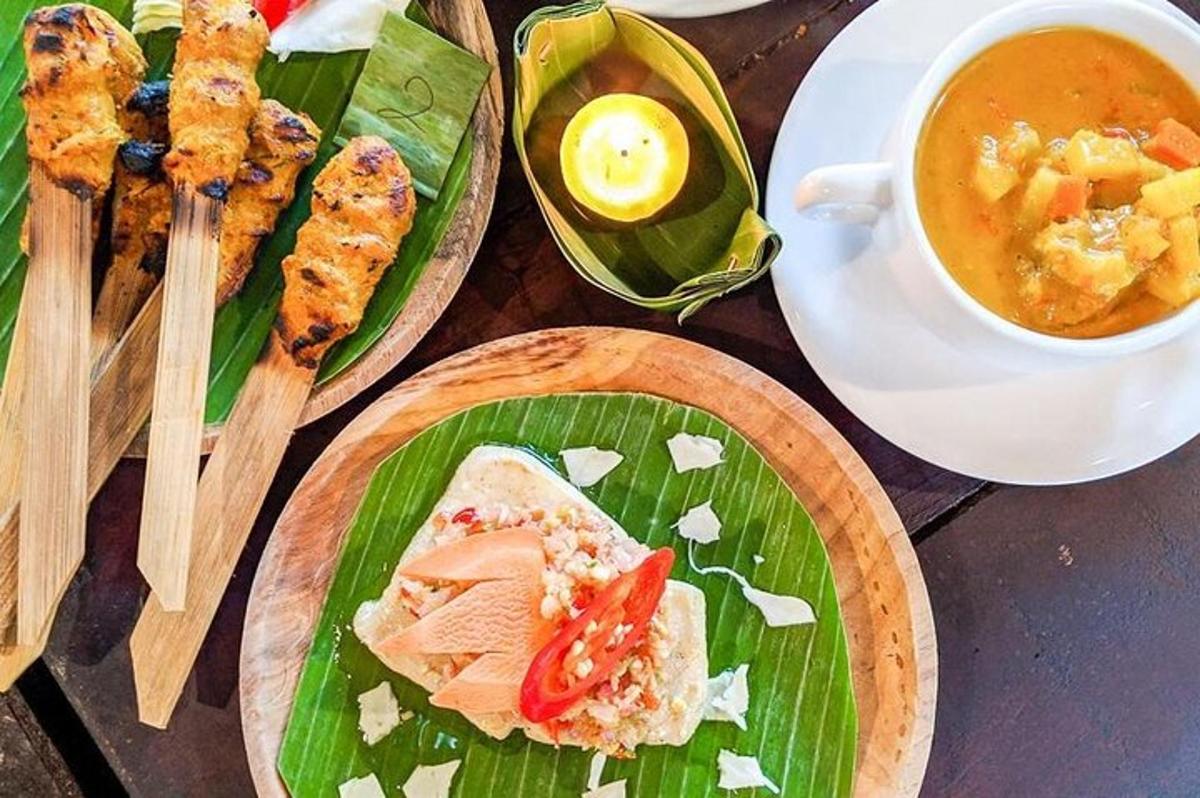 a table with plates of food and a cup of soup