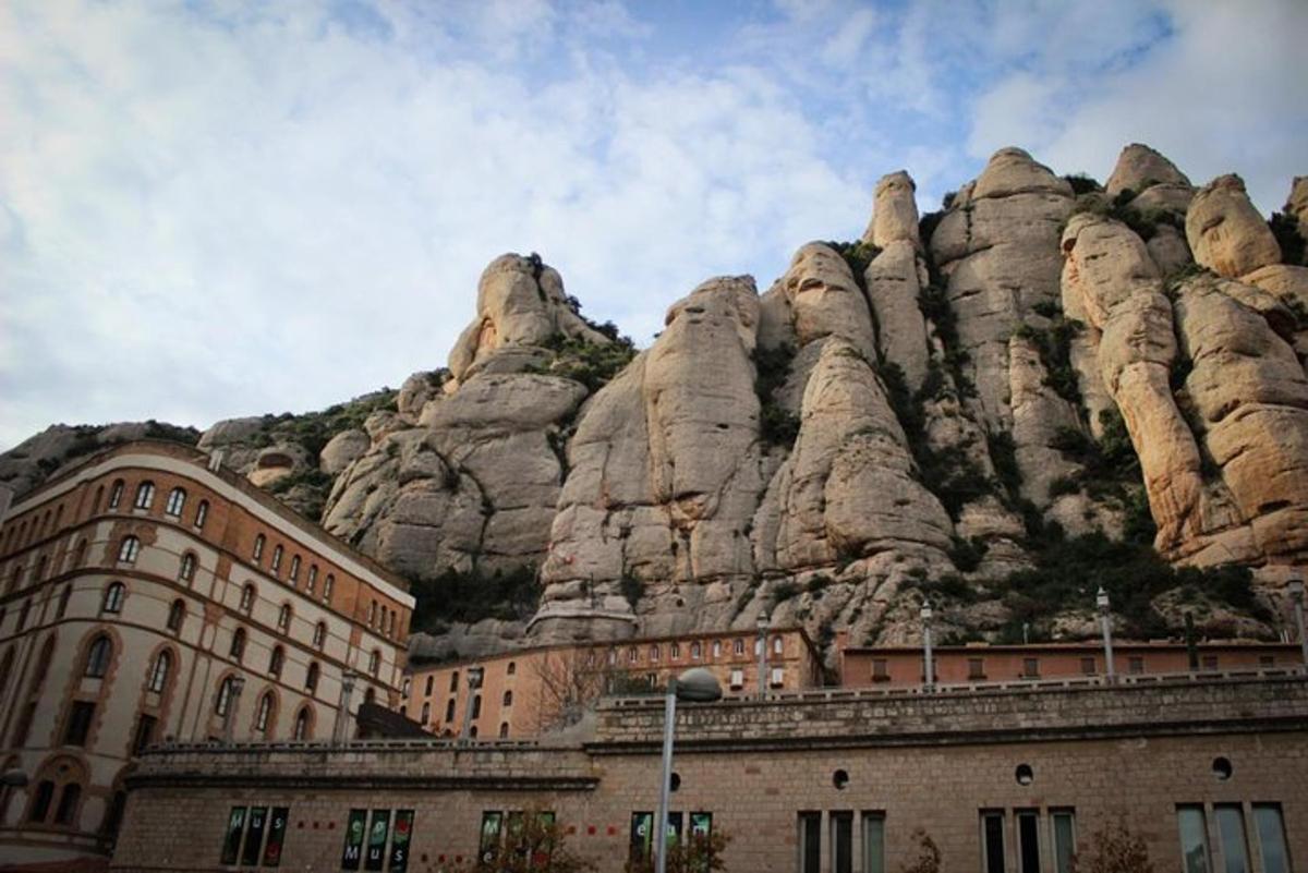 a large mountain with rocks on top of a building