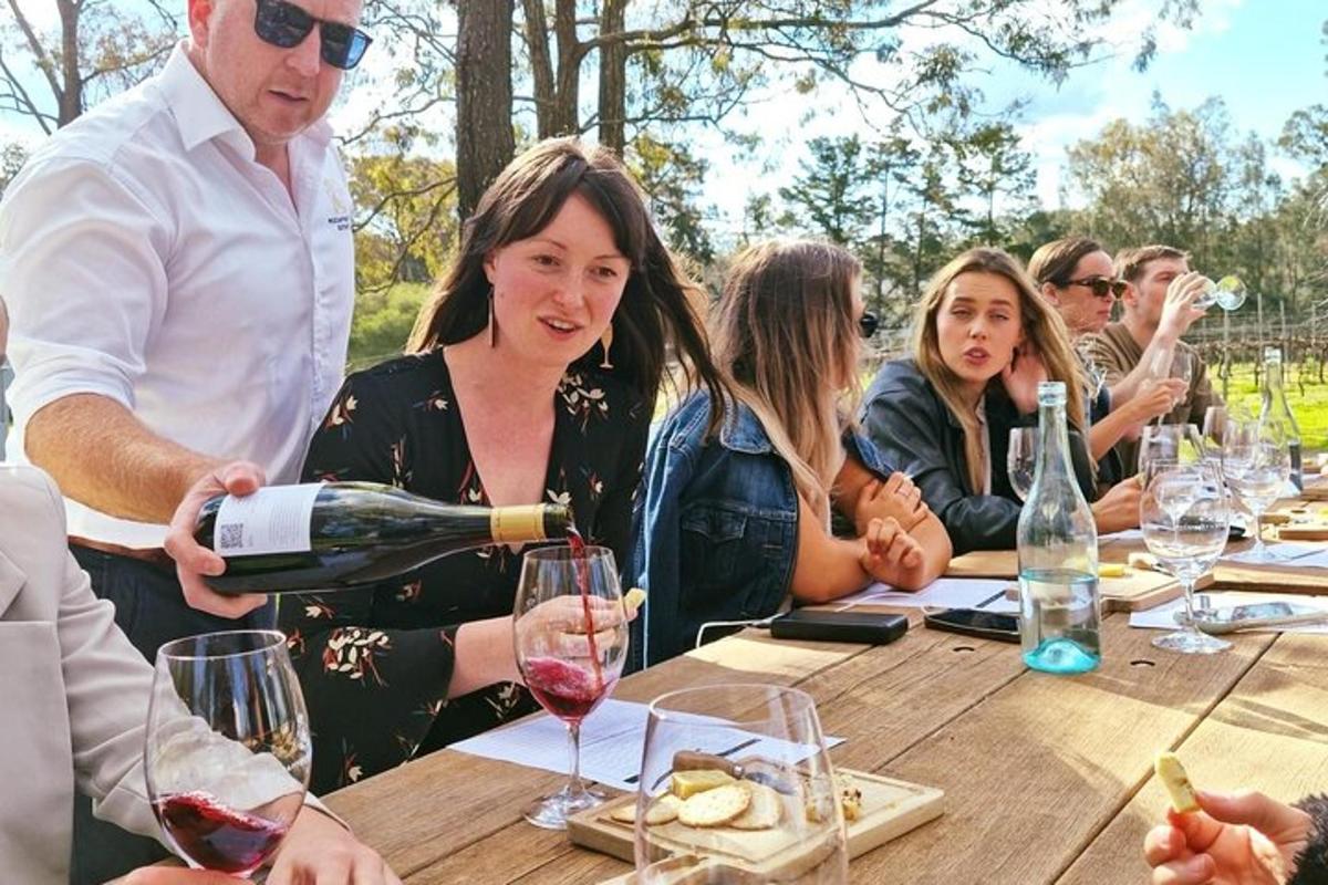 a group of people sitting at a table drinking wine