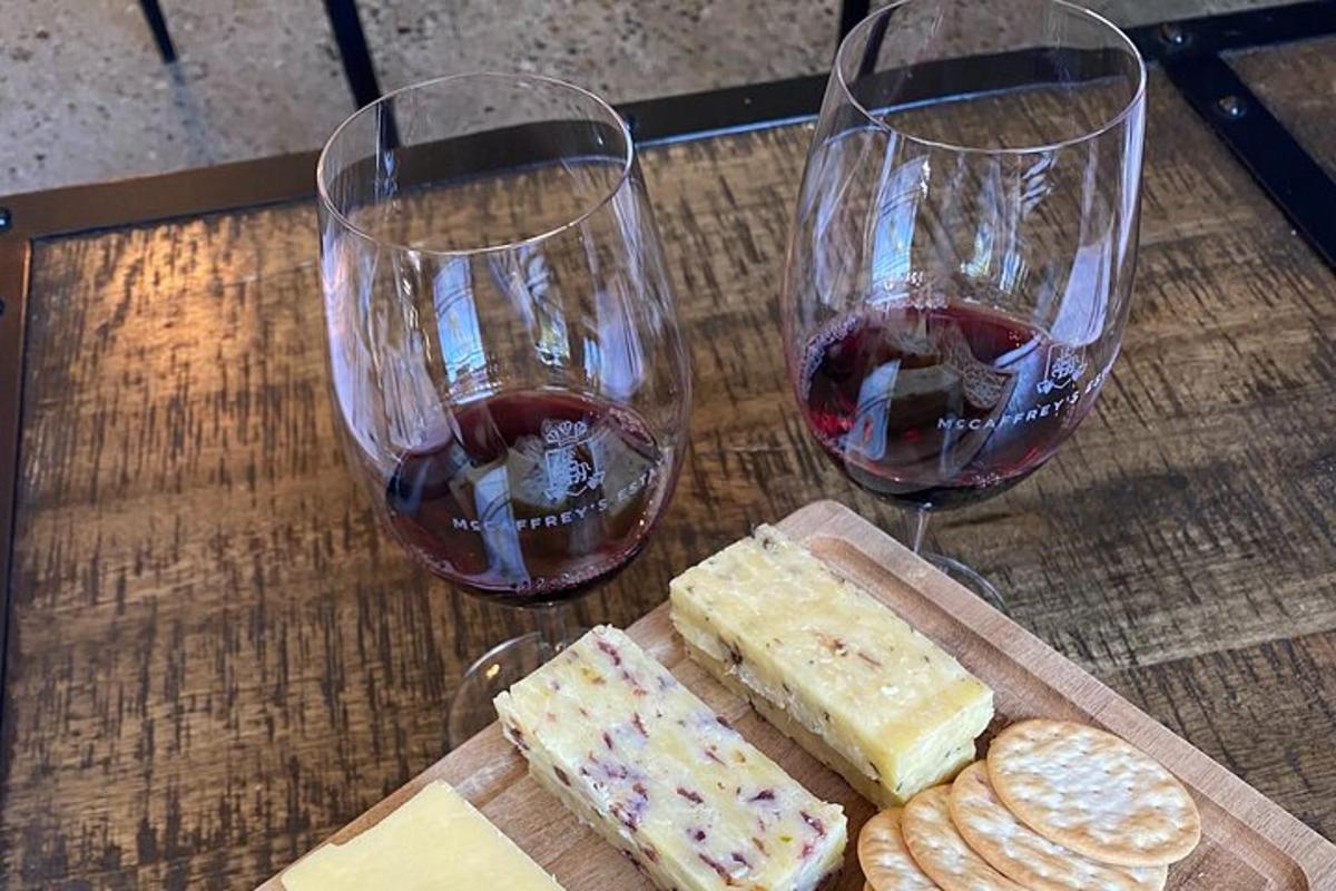 two glasses of wine and cheese and crackers on a table