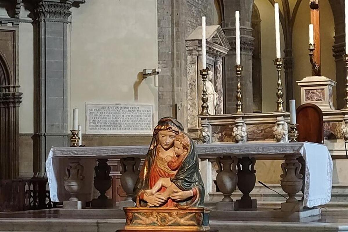 a statue of a woman sitting on a altar in a church