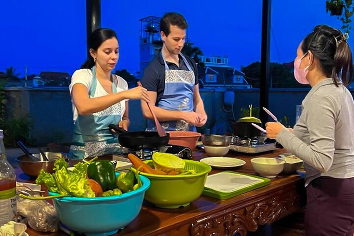 a group of people standing around a table preparing food