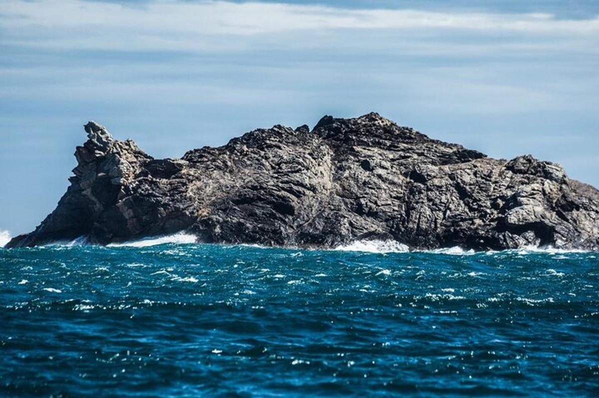 a rock in the middle of the ocean