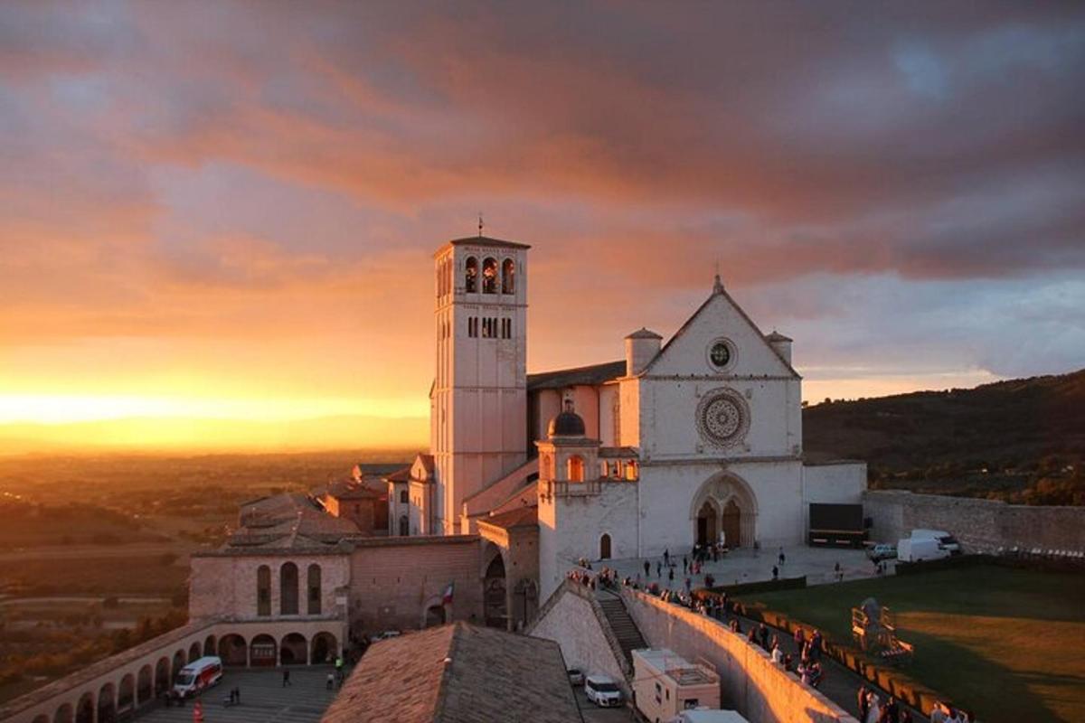a church with a clock tower on a hill
