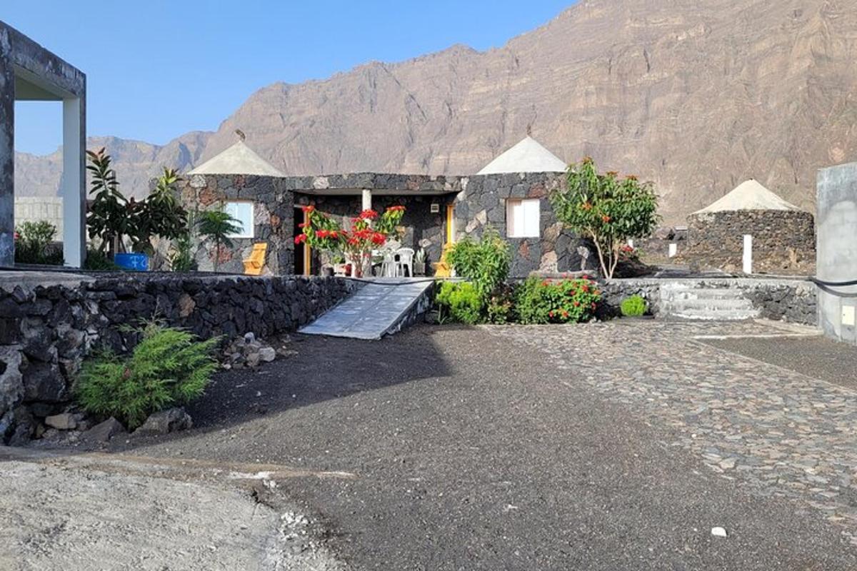 a stone building with a mountain in the background