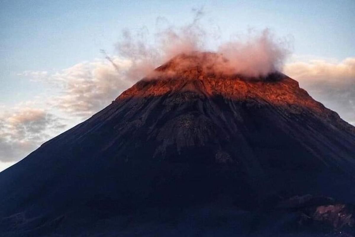 a mountain with smoke on top of it