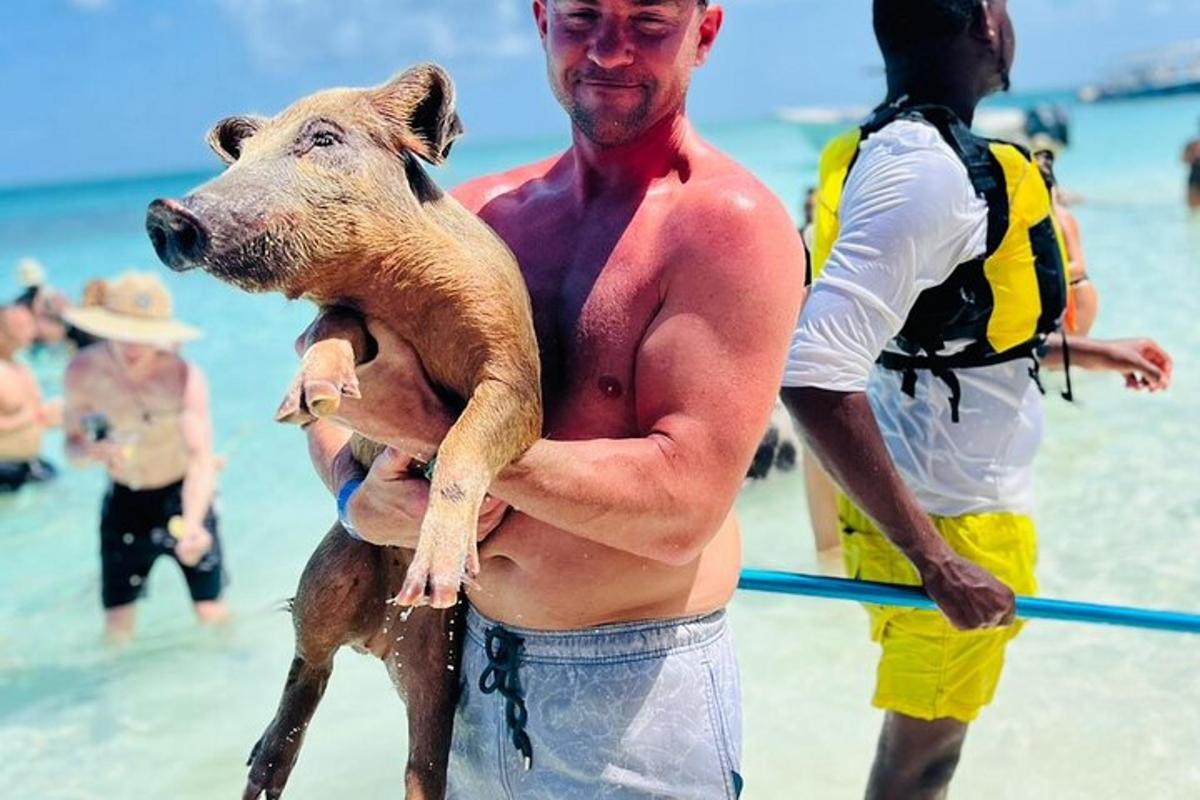a man holding a dog on the beach