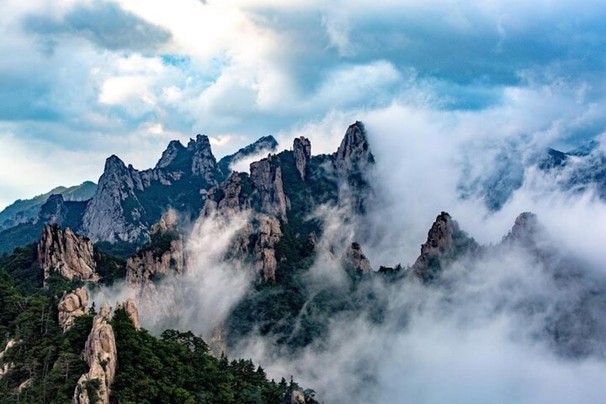 a mountain range with clouds in front of it