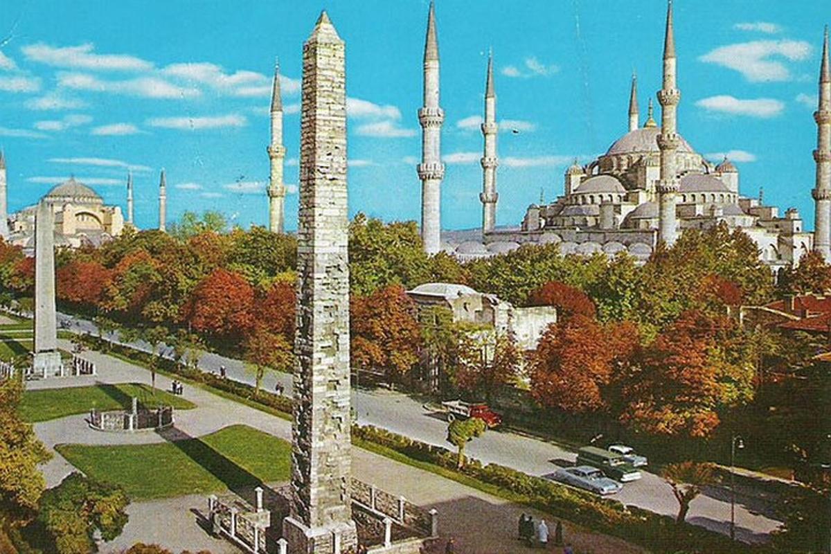 a view of a mosque with a tall pole in a city