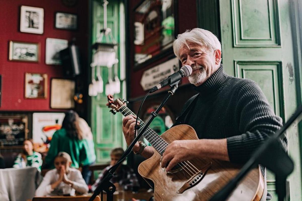 a man playing a guitar and a microphone