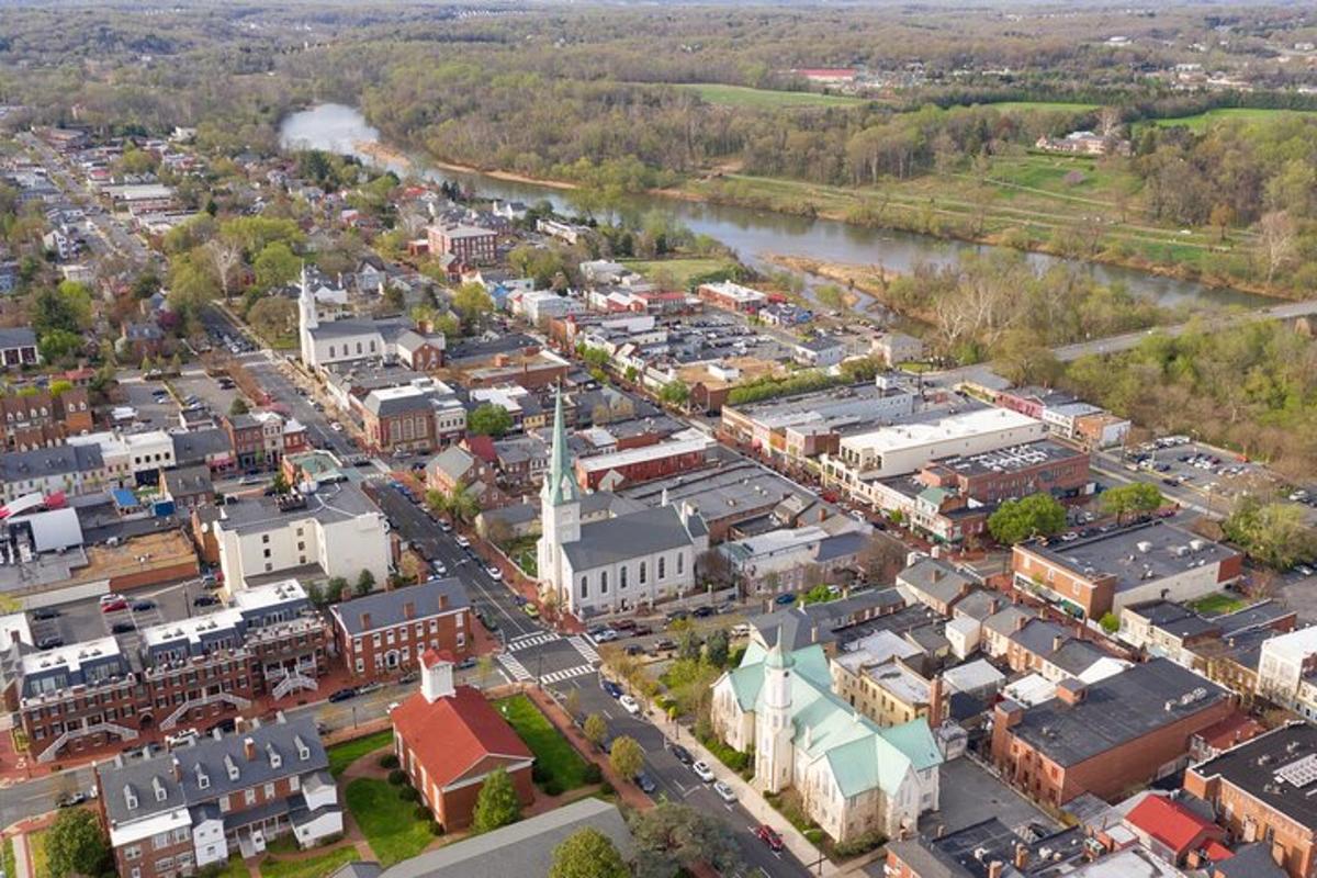 an aerial view of a small town next to a river