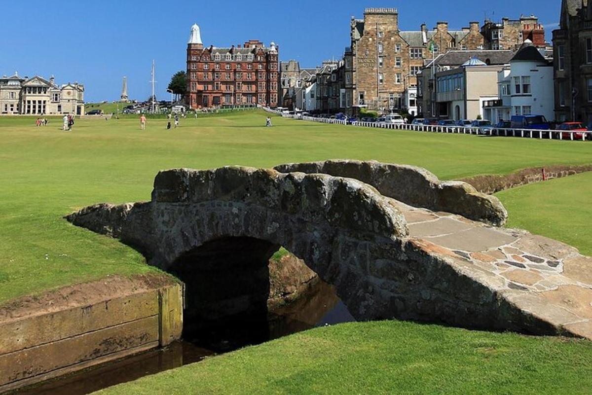 a stone bridge over a river in a city