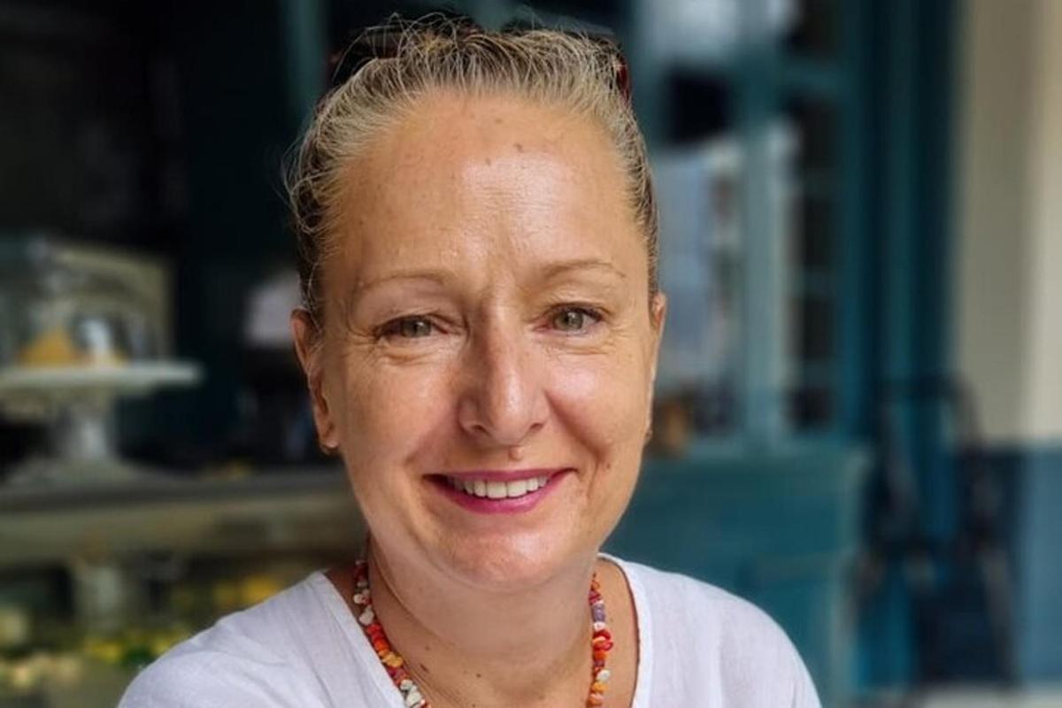 a woman is smiling at the camera