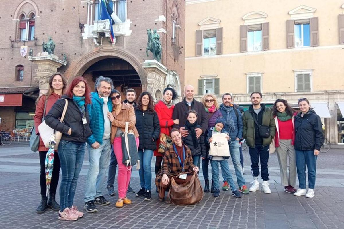 a group of people posing for a picture in front of a building