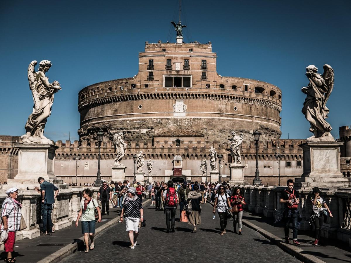 a group of people walking in front of a building