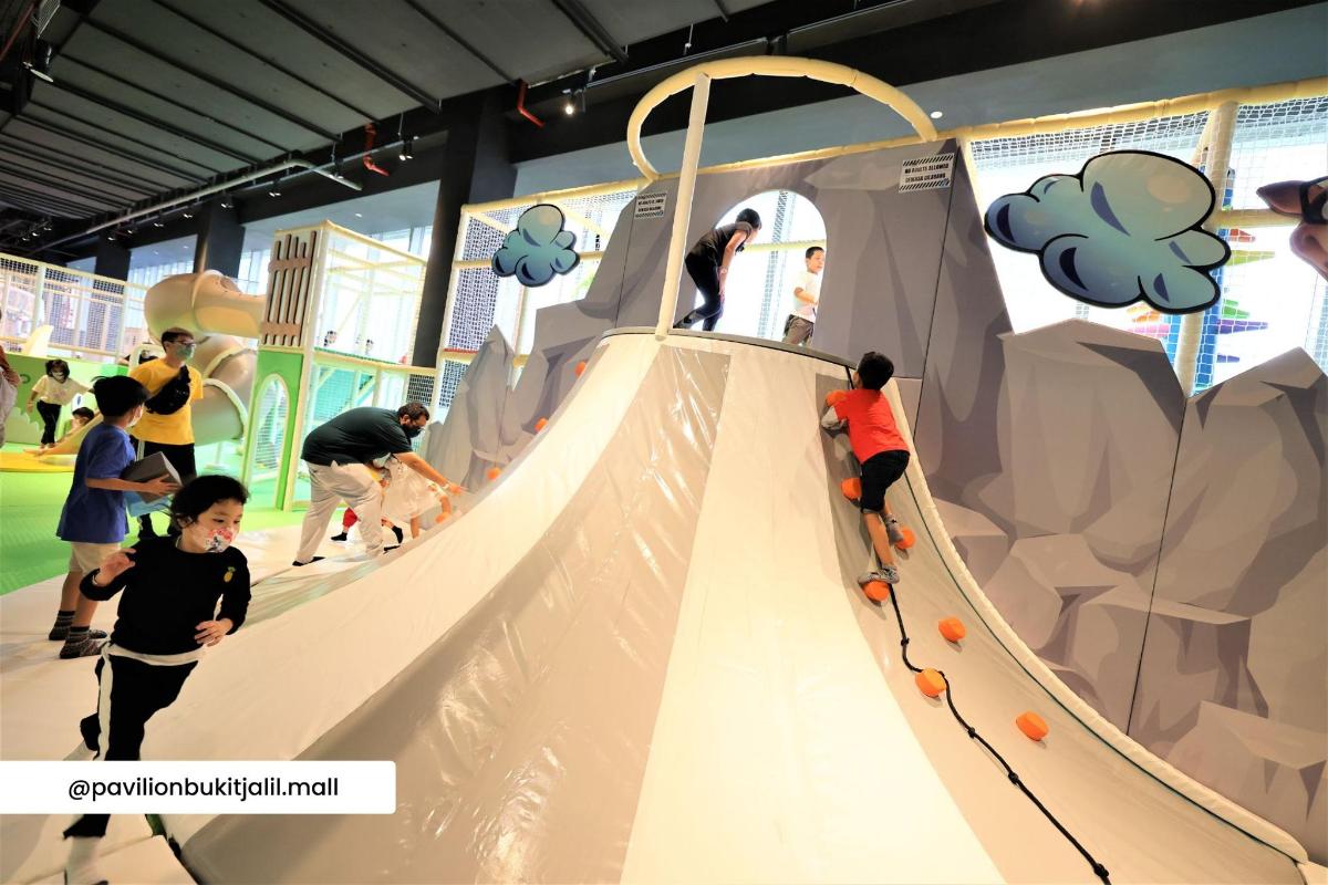 a group of people playing on an indoor playground