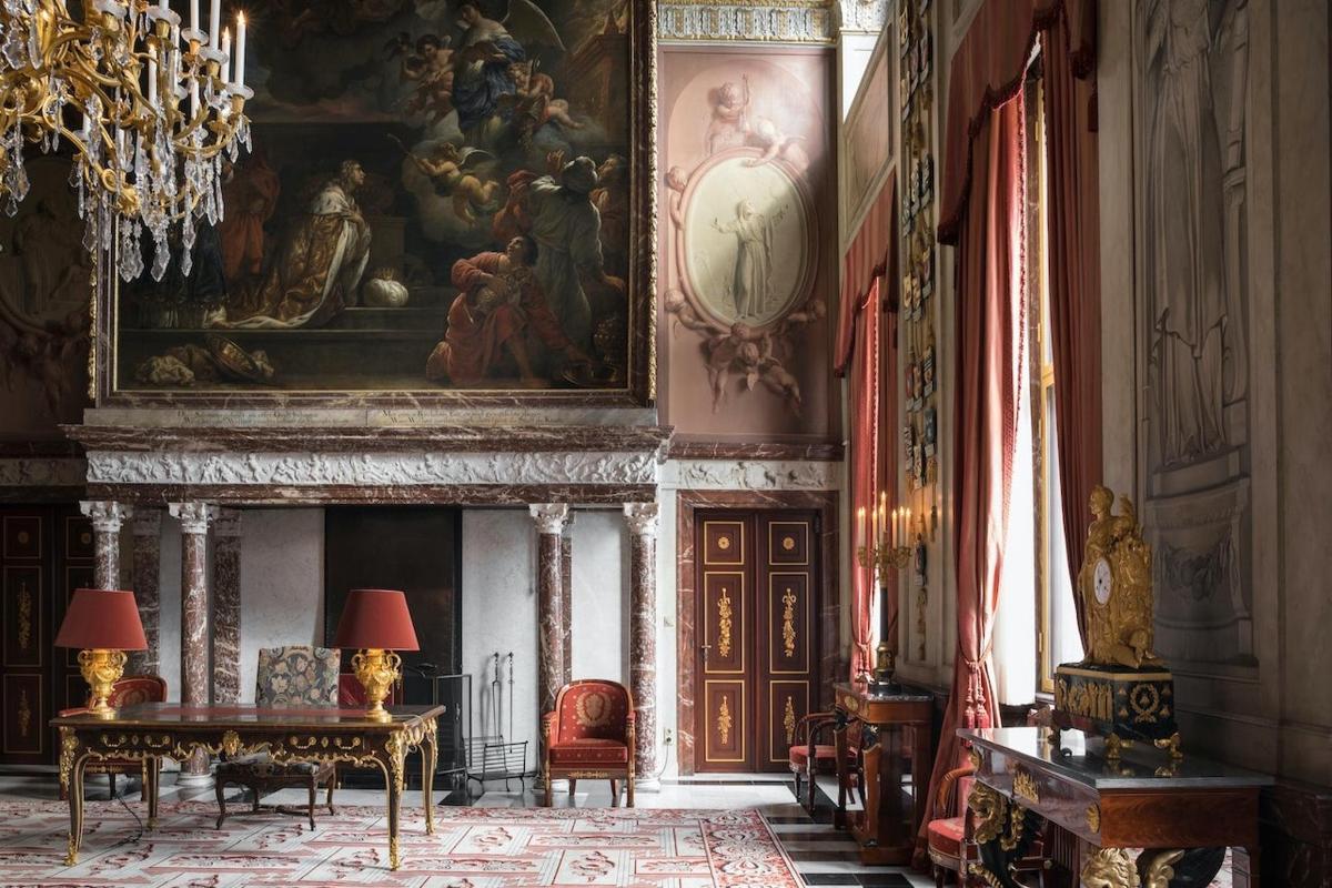a room with a fireplace and a painting on the wall
