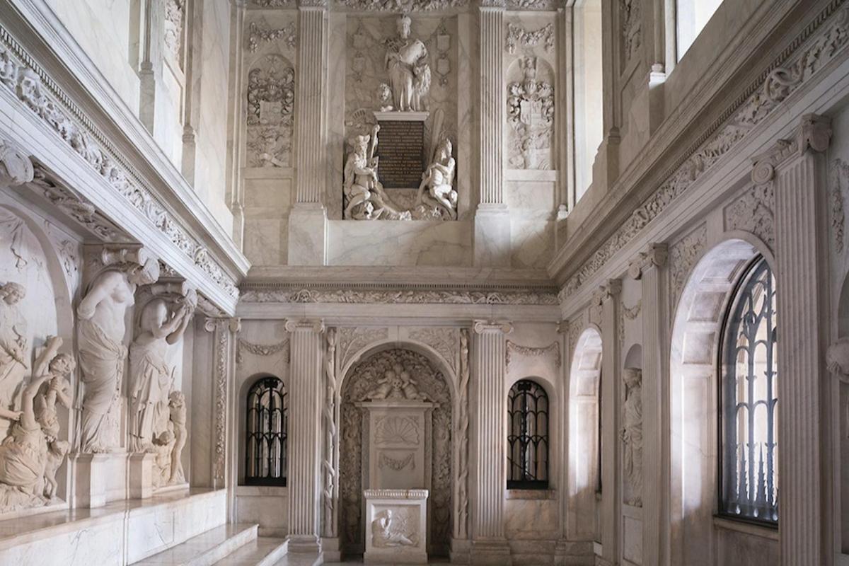 a large building with statues on the ceilings and a door