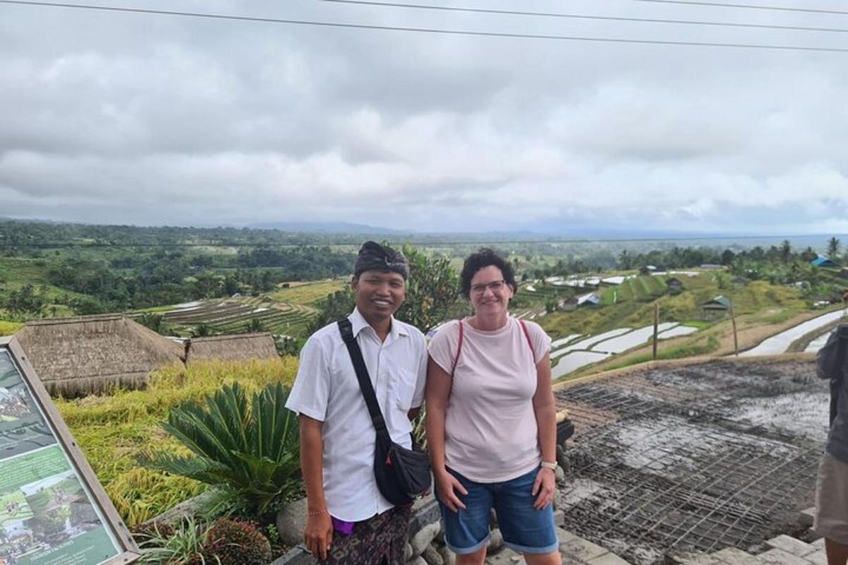 a man and a woman standing on top of a mountain