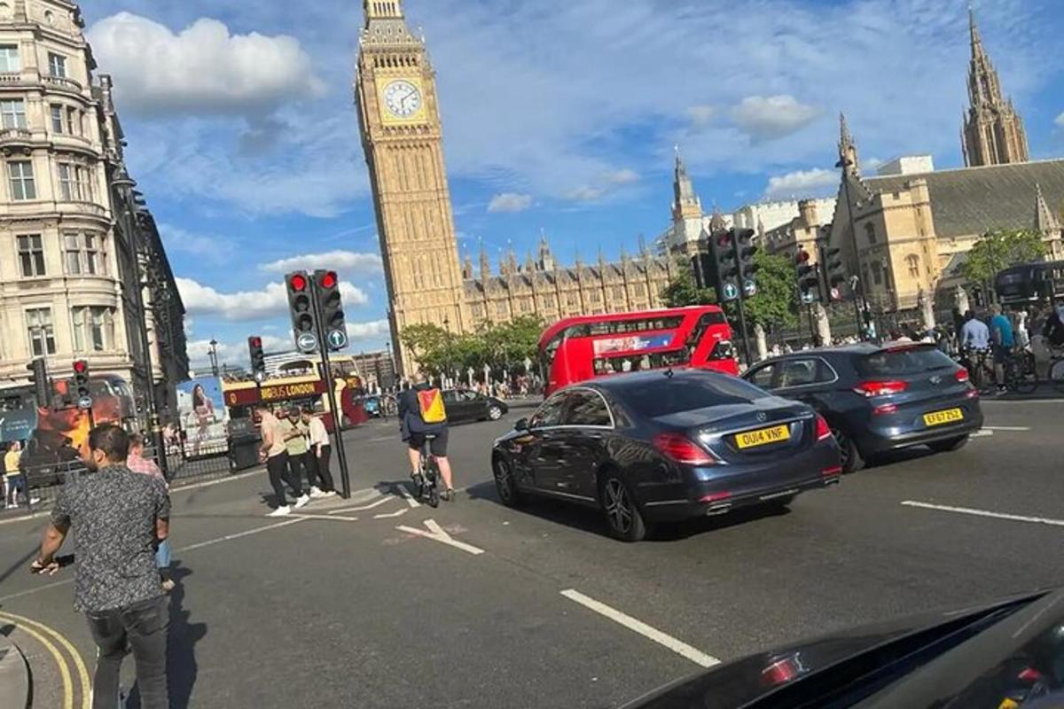 a busy city street with a clock tower and big ben