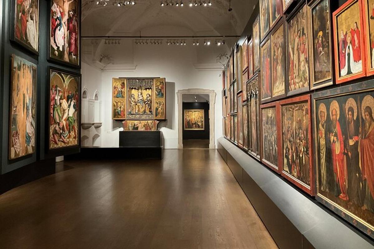 a room with a bunch of paintings on the wall