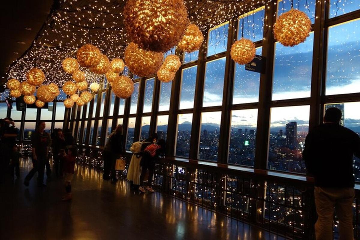a group of people standing in a building with lights
