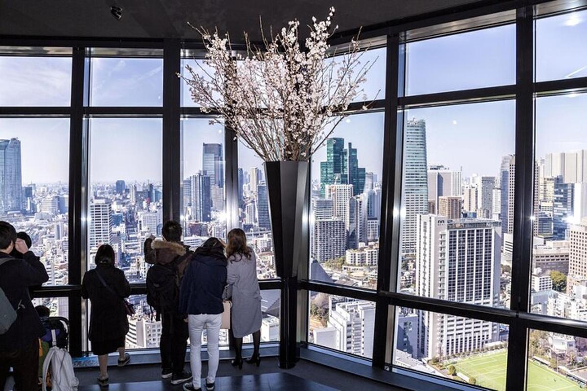 a group of people standing in a room looking at the city